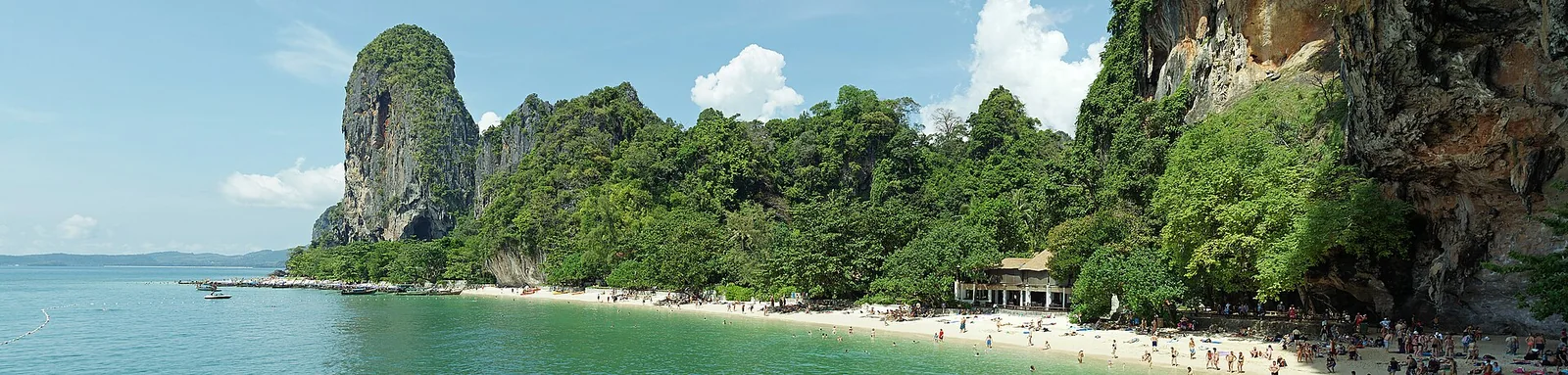 A panorama of the sand, wooded cliffs and water at Phra Nang Beach on the Railay peninsula